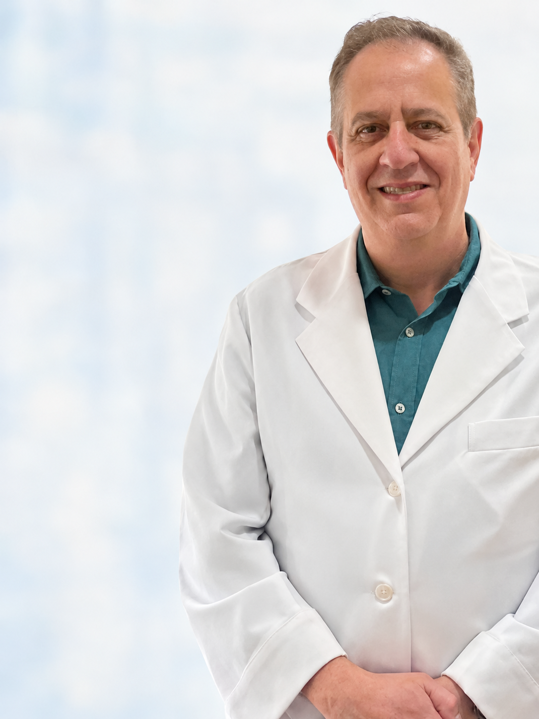 Dr. Hudson Magacho usando jaleco branco em retrato profissional